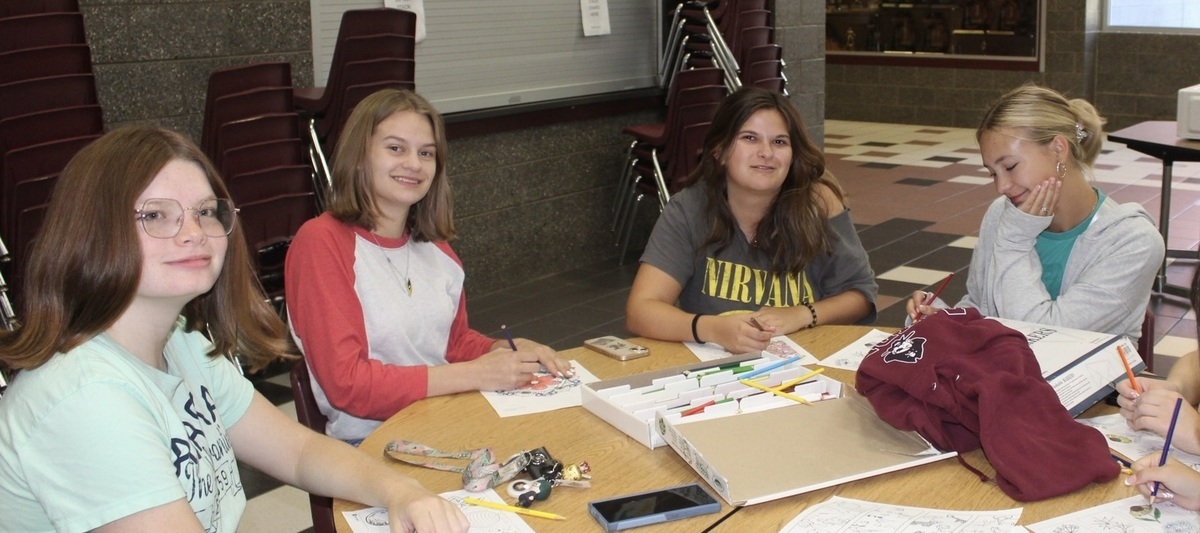 students at a table doing school work